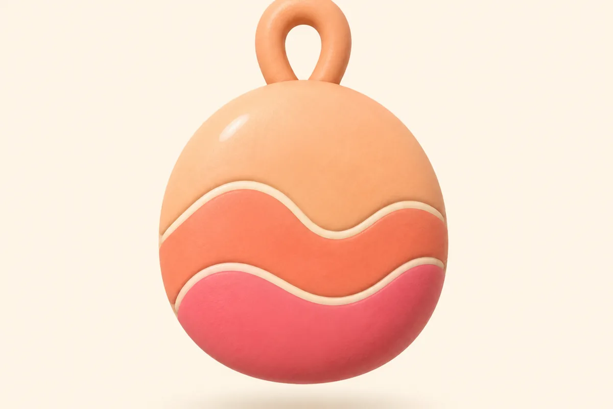 A memory you can pick back up A single round clay pebble banded in peach, coral and rose, with a small loop rising from the top of it